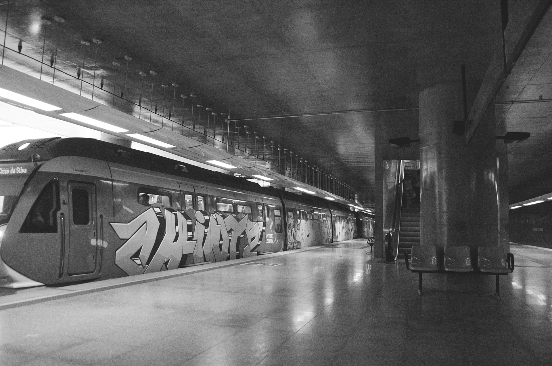 Grayscale photograph of the graffiti-covered train at Benfica Metro Station in Fortaleza